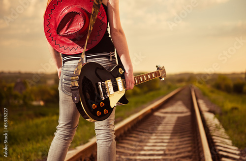 Photo: woman with guitar at railway road woman with guitar at railway road