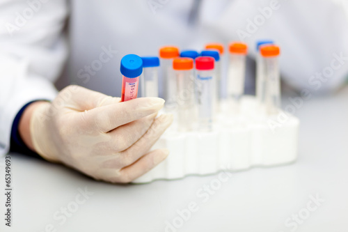 Photo: Scientist looking at a test tube Scientist looking at a test tube