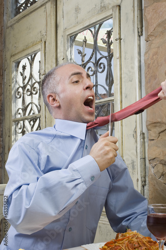 Photo: Strangled with a tie / Man cuts his tie and tries to get off . Strangled with a tie / Man cuts his tie and tries to get off .