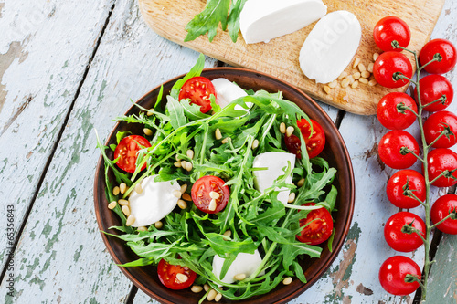 Photo: arugula salad with mozzarella cheese and cherry tomatoes arugula salad with mozzarella cheese and cherry tomatoes