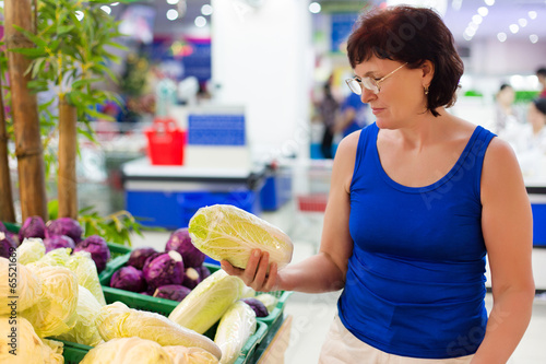Photo: woman buys cabbage woman buys cabbage