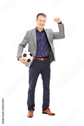 Photo: Young football fan cheering with ball in hand Young football fan cheering with ball in hand