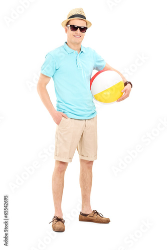 Photo: Young man holding a beach ball Young man holding a beach ball