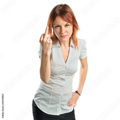 Photo: young girl making horn gesture over white background young girl making horn gesture over white background