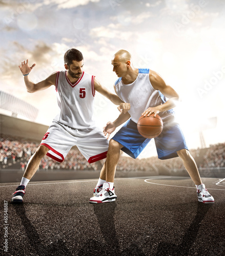 Photo: Basketball player in action on background of sky and crowd Basketball player in action on background of sky and crowd
