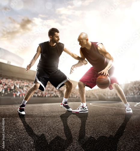 Photo: Basketball player in action on background of sky and crowd Basketball player in action on background of sky and crowd