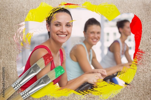 Photo: Composite image of spinning class in the gym Composite image of spinning class in the gym