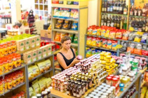 Photo: Woman checking food labelling Woman checking food labelling