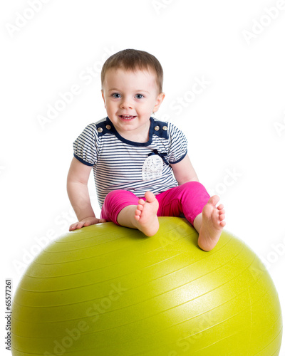 Photo: kid girl doing fitness exercise with fitness ball kid girl doing fitness exercise with fitness ball