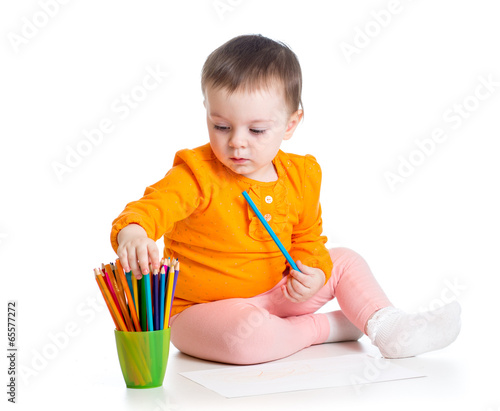 Photo: cute girl drawing with colourful pencils cute girl drawing with colourful pencils