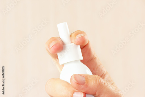 Photo: Female hand holding a medical spray close up Female hand holding a medical spray close up