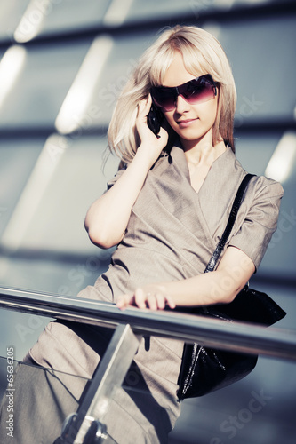 Photo: Blond fashion woman calling on the cell phone Blond fashion woman calling on the cell phone