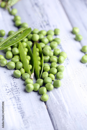 Photo: Fresh green peas on wooden background Fresh green peas on wooden background