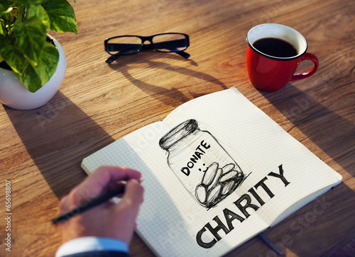 Photo: Man with Note Pad and Charity Concepts Man with Note Pad and Charity Concepts
