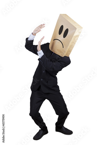 Photo: Scared businessman keeping his face Scared businessman keeping his face