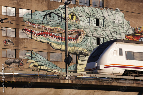 Photo: Lizard graffiti on a building facade and train Lizard graffiti on a building facade and train