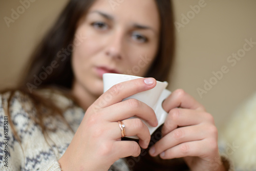 Photo: woman holding cup woman holding cup