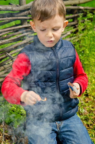 Photo: Child striking a match Child striking a match