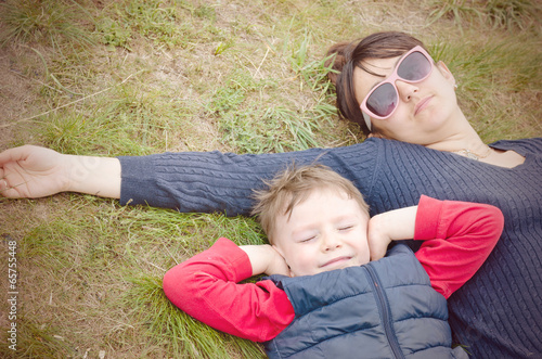 Photo: Mother and her young son lying on the ground Mother and her young son lying on the ground