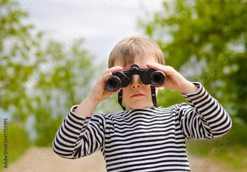 Photo: Little boy scanning the woods with binoculars Little boy scanning the woods with binoculars