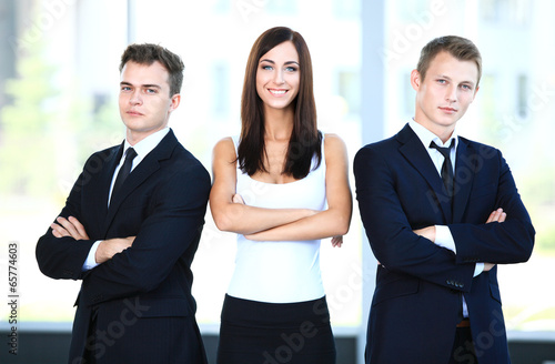 Photo: professional business team looking confidently at camera professional business team looking confidently at camera