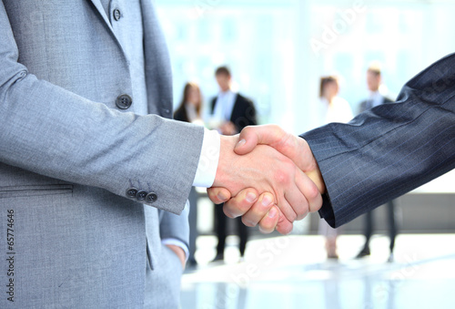 Photo: Business people shaking hands, finishing up a meeting Business people shaking hands, finishing up a meeting