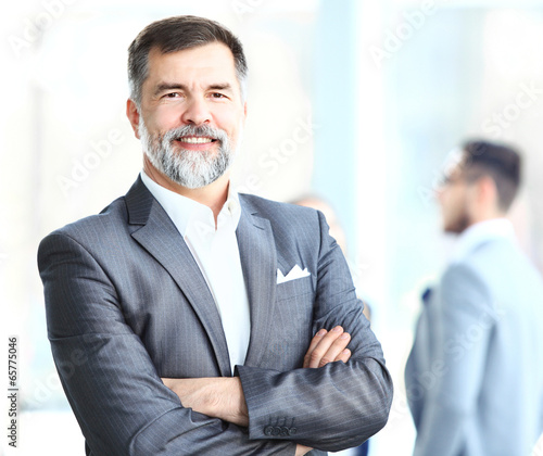 Photo: Portrait of a happy senior business man smiling Portrait of a happy senior business man smiling
