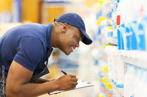 Photo: african hardware store worker taking stock african hardware store worker taking stock