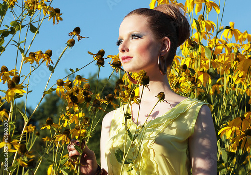 Photo: Woman Outside among Flowers in Meadow Woman Outside among Flowers in Meadow