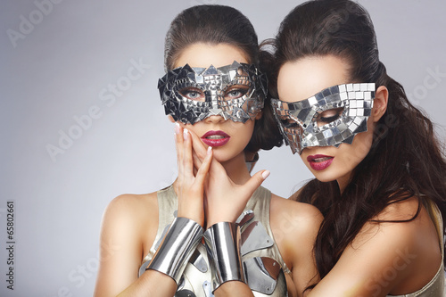 Photo: Masquerade. Artistic Women in Fancy Bright Glasses Masquerade. Artistic Women in Fancy Bright Glasses