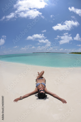 Photo: beautiful young woman on beach have fun and relax beautiful young woman on beach have fun and relax