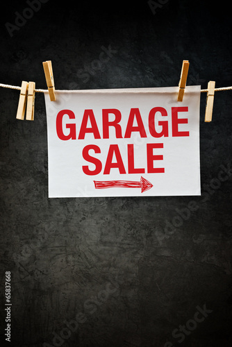 Photo: Garage Sale sign hanging on clothes rope Garage Sale sign hanging on clothes rope