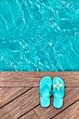 Blue flip flops on a wooden deck Blue flip flops on a wooden deck