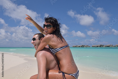 Photo: happy young couple have fun on beach happy young couple have fun on beach