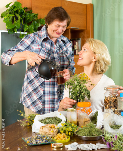 Photo: women relaxing at home and drinking tea women relaxing at home and drinking tea