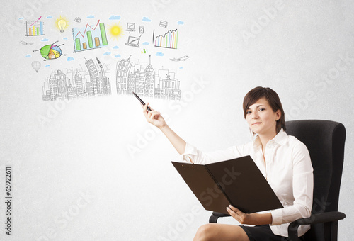 Photo: Cute woman sketching city and graph icons Cute woman sketching city and graph icons