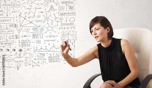 Photo: Young woman sketching and calculating thoughts Young woman sketching and calculating thoughts