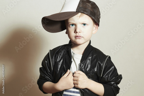 Photo: Fashionable Child. little boy in tracker Cap.fashion children Fashionable Child. little boy in tracker Cap.fashion children