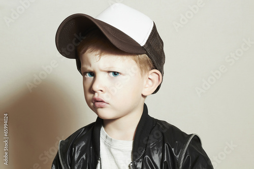Photo: little boy.fashion children.Boy in Tracker Hat.Sad Child little boy.fashion children.Boy in Tracker Hat.Sad Child