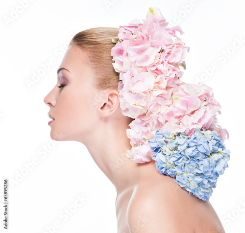 Photo: Profile portrait of young beautiful woman with flowers Profile portrait of young beautiful woman with flowers