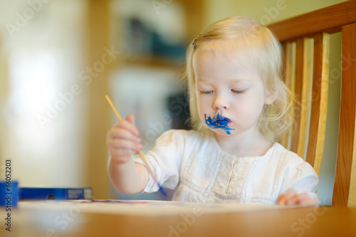 Photo: Funny grimy toddler girl painting Funny grimy toddler girl painting