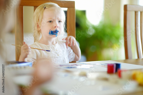 Photo: Funny grimy toddler girl painting Funny grimy toddler girl painting