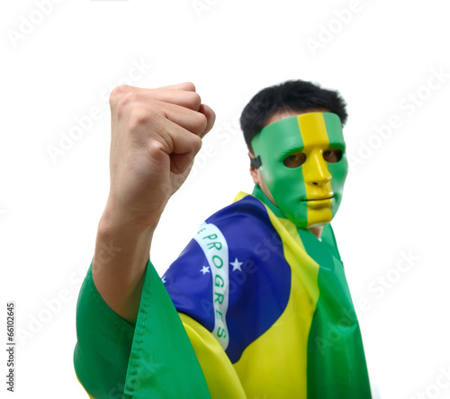 Photo: Brazilian man celebrates with flag and mask Brazilian man celebrates with flag and mask