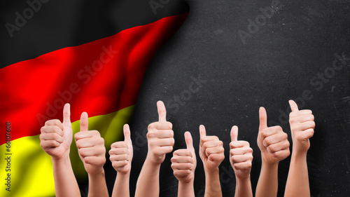 Photo: Daumen-Hoch-Gesten vor Deutschlandfahne Daumen-Hoch-Gesten vor Deutschlandfahne