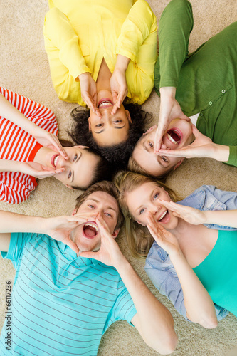 Photo: smiling people lying down on floor and screaming smiling people lying down on floor and screaming