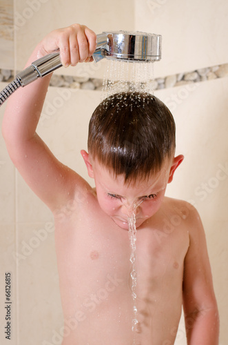 Photo: Boy holding shower over his head Boy holding shower over his head