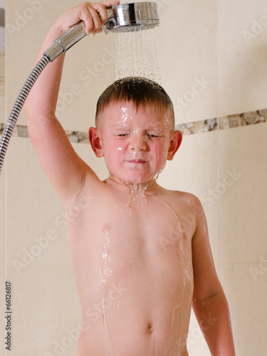 Photo: Boy holding shower over his head Boy holding shower over his head