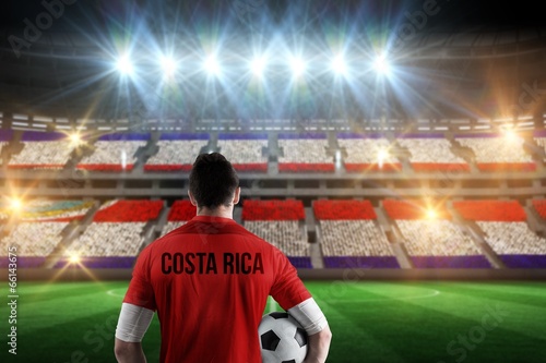 Photo: Composite image of costa rica football player holding ball Composite image of costa rica football player holding ball