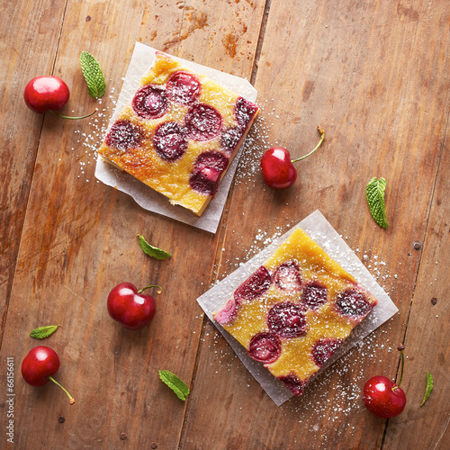 Photo: Cherry clafoutis pie portions on wooden table Cherry clafoutis pie portions on wooden table