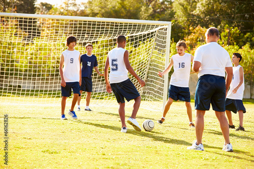 Photo: Members Of Male High School Soccer Playing Match Members Of Male High School Soccer Playing Match
